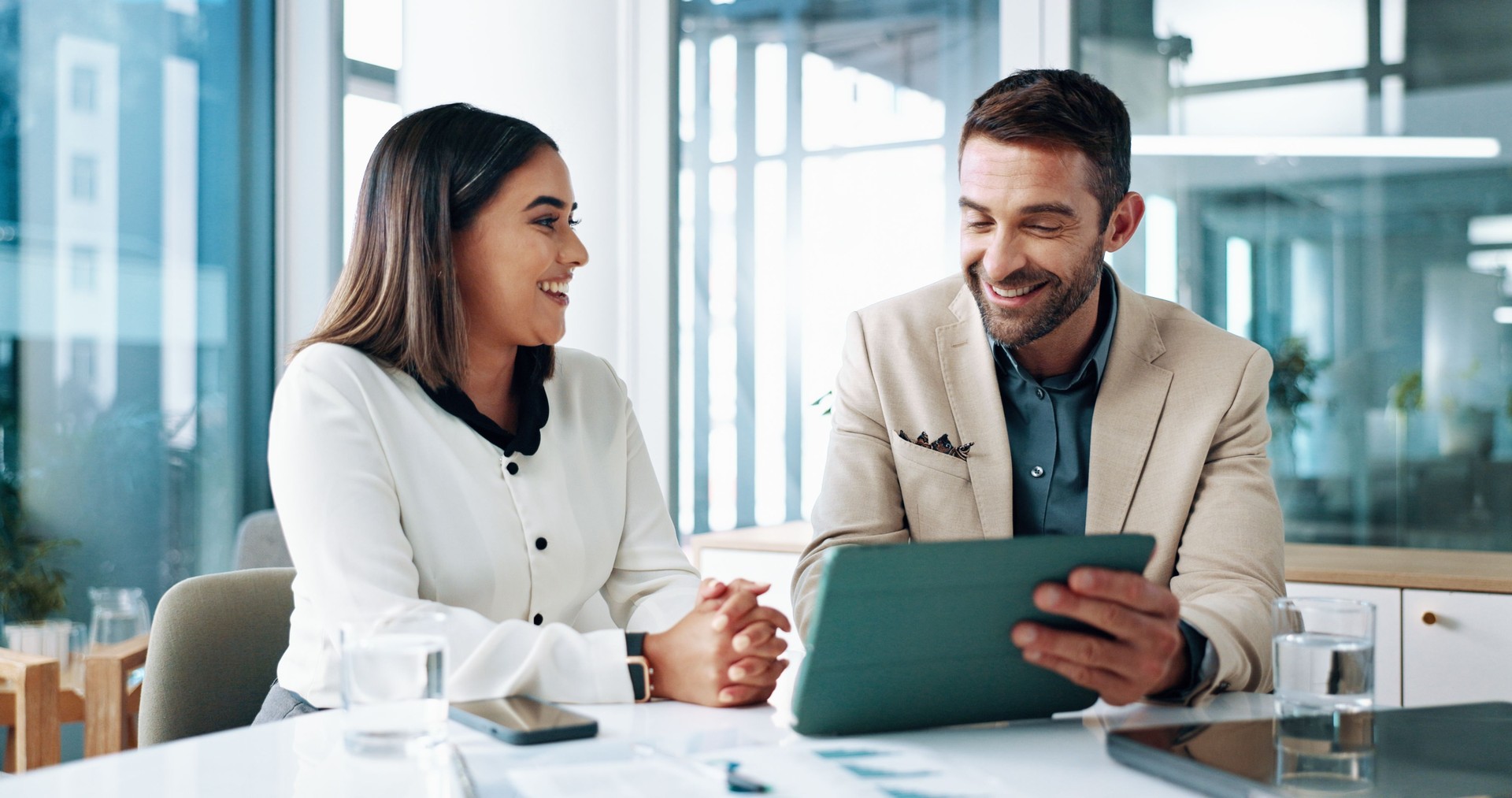 Happy, teamwork and people with tablet, business and review of ad campaign performance or media buyer. Collaboration, smile and tech for digital marketing in office, website and discussion in meeting